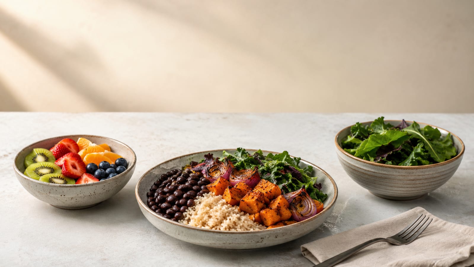 Plant-based recovery bowl with beans, rice, fruit, greens, and colorful vegetables